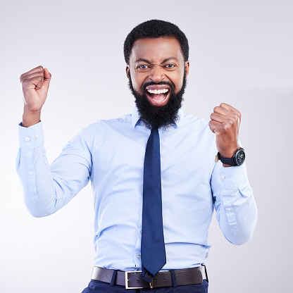 Success, fist and black man portrait isolated on gray background in celebration for career opportunity, bonus or winning. Winner or business person celebrate corporate promotion or job news in studio