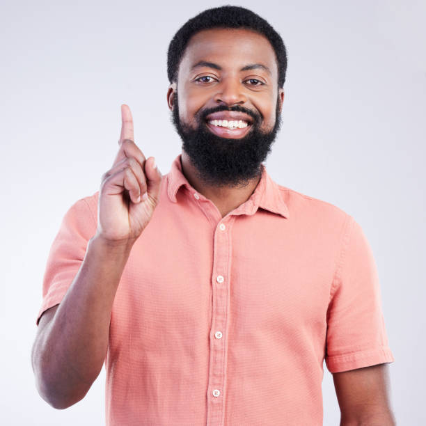 istock Black man, studio portrait and point finger for answer, question and smile with confidence by background. Young model, african student and hand gesture with happiness on face for fashion by backdrop 1494262253