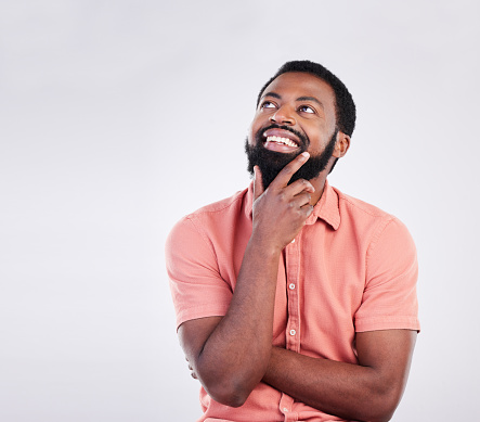 Thinking, mockup space and face of black man with hand gesture for brainstorming, ideas and thoughtful. Happy, smile and male on white background pose for choice, decision and wondering in studio