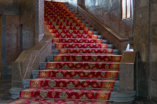 a view of a red carpeted steps of a stairs | colorful