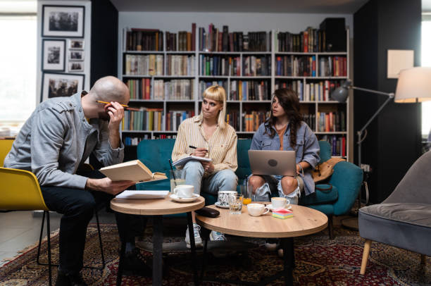 istock Group of three gen Z university students working together at laptop, writing notes, watching learning webinar, online lecture, reading tutorials on internet in college library. Education concept 1494268812