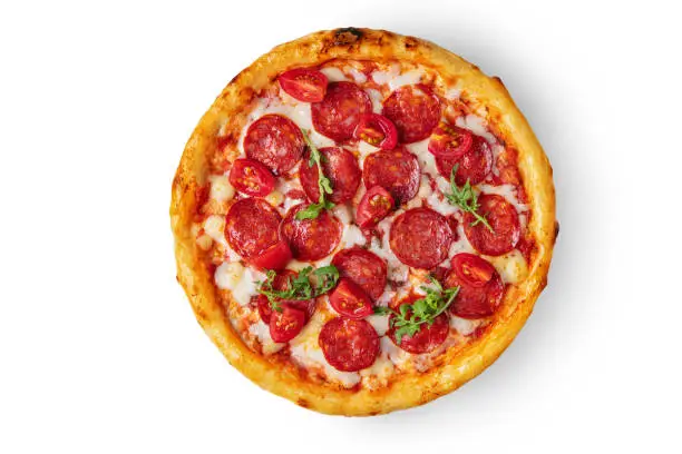 Pizza with pepperoni, arugula, ketchup, tomatoes and cheese in a plate on a white background