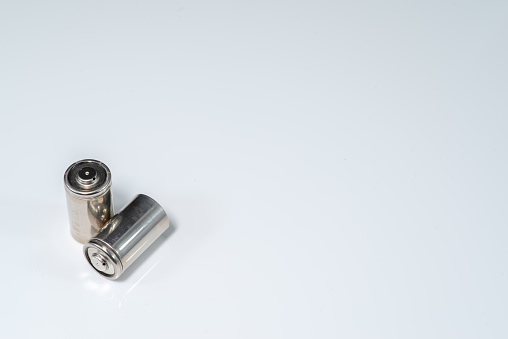 Alkaline batteries lie on white background, The concept of vital energy reserve
