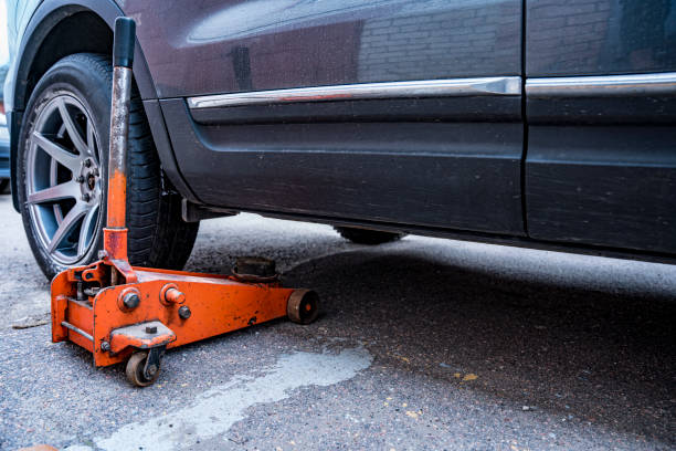 istock car is jacked using an automobile hydraulic jack 1494273616