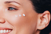 Anti-aging Skin Care: Close up Shot of Face Cream on a Woman's Cheekbone