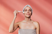 Portrait of a Beautiful Caucasian Woman Applying Makeup with a Brush