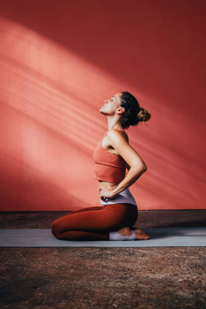 Beautiful Caucasian Woman Doing Yoga on a Mat stock photo