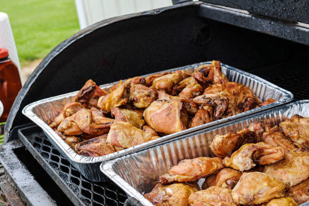 istock marinated and seasoned chicken breasts on a charcoal grill 1494275566