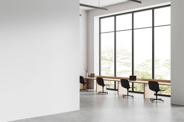 istock White business interior with coworking corner and panoramic window. Mockup wall 1494277480