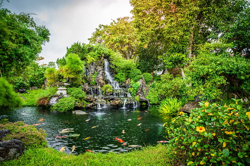 Beautiful garden with waterfall behind Thien Mu Temple in Hue, Vietnam
