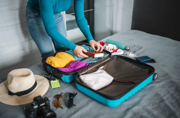 istock Woman packing suitcase for travel. 1494280376