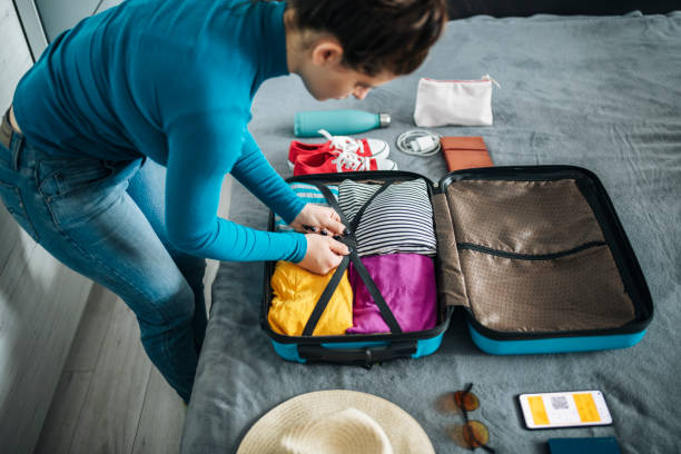istock Woman packing suitcase for travel. 1494280404