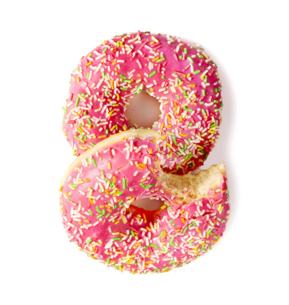 istock Two donuts decorated with colorful sprinkles isolated on white background 1494281732