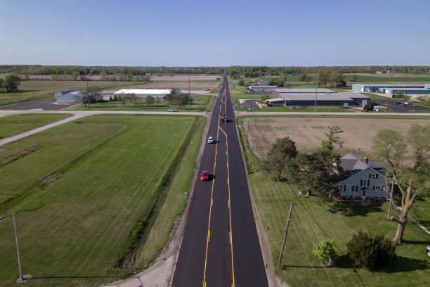 istock county road with green grass and industrial park 1494281966