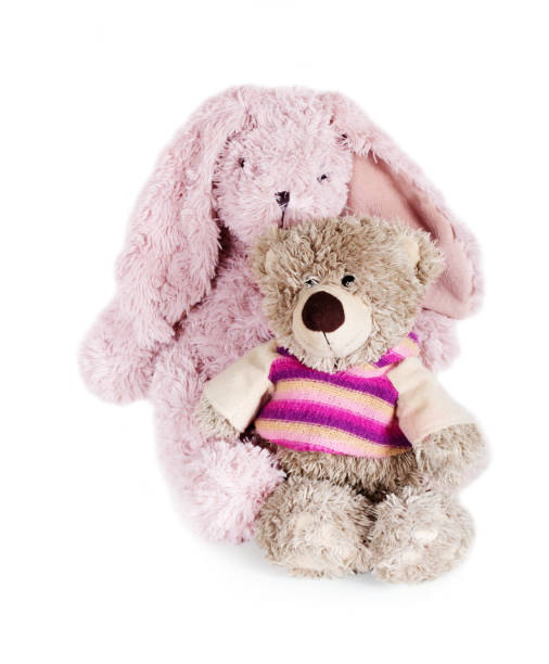 istock Toy soft teddy bear and rabbit sittind on white background 1494282376