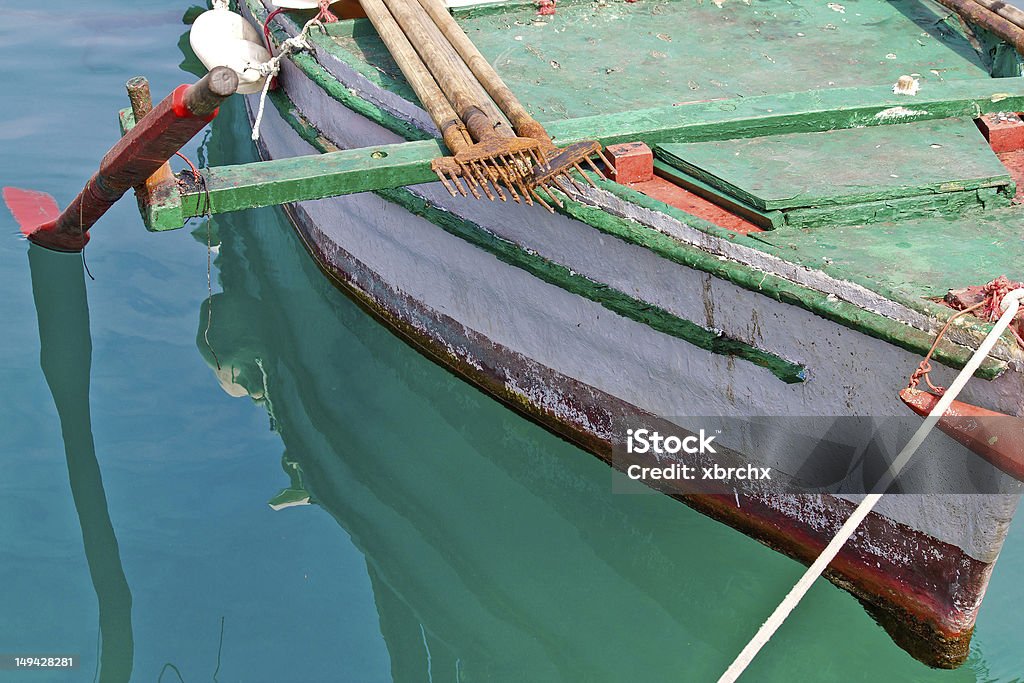Old wooden fishing boat detail Old wooden colorful fishing boat detail with rusty fish gig Adriatic Sea Stock Photo