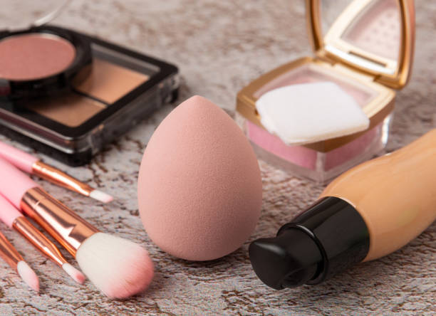 istock Beauty blender with foundation, powder, blush and makeup brushes on a marble background.Bright sponges for makeup cosmetics. Makeup products. Beauty concept. Place for text. Space for copy. Flat lay 1494283831