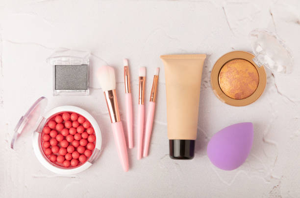 istock Beauty blender with foundation, powder, blush and makeup brushes on a marble background.Bright sponges for makeup cosmetics. Makeup products. Beauty concept. Place for text. Space for copy. Flat lay 1494283848