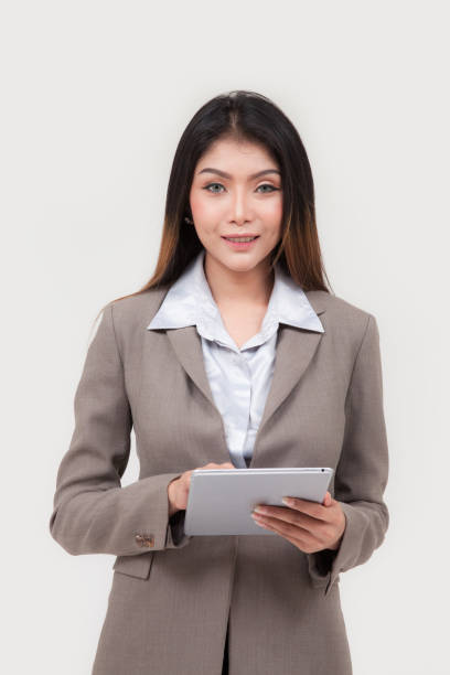 istock business woman hold tablet on white background 1494284242