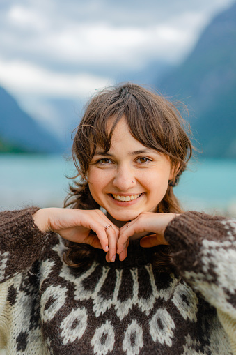 Close up portrait of  Caucasian woman on the background of Norwegian lake in summer