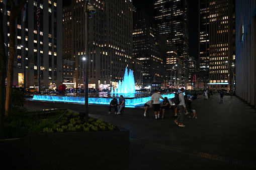 New York, USA, April 13, 2023 - Illuminated fountain on 6th ave in evening light, Manhattan, New York.