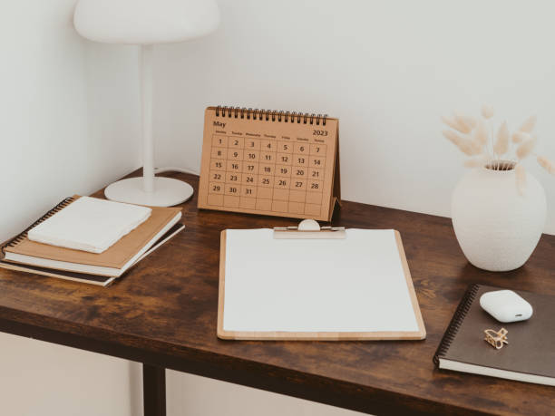 istock Clipboard with blank paper with copy space on wood brown desk. 1494287204
