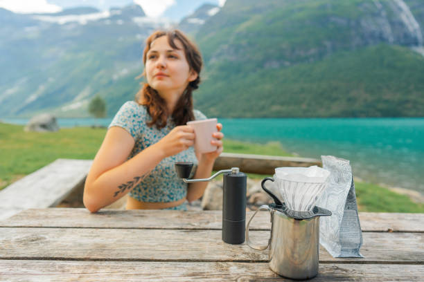 Woman brewing coffee in nature