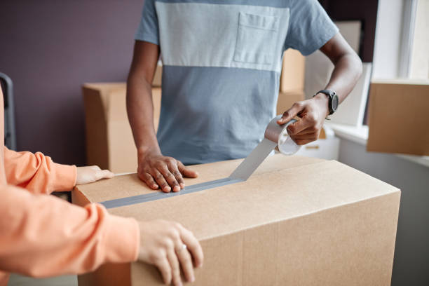 istock Couple using adhesive tape for packing 1494289165