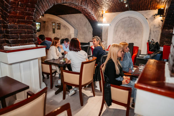 istock Group Of Mid Adults Relaxing In A Bar 1494289741