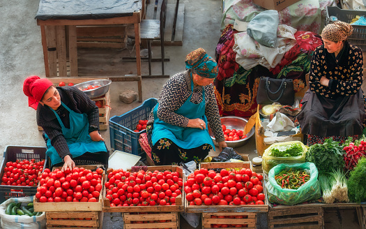 Khujand, Tajikistan . October 17, 2019: Vegetable sellers women . The Panchshanbe bazaar is one of the largest bazaars in Central Asia.