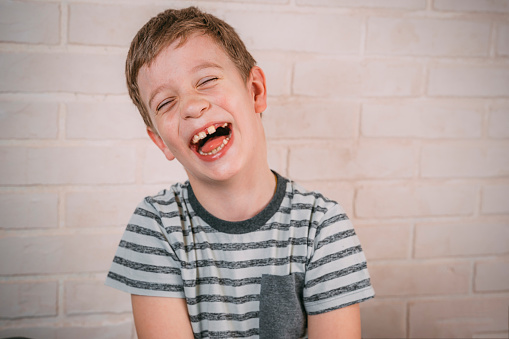 cute boy happy funny expression. Portrait of emotional overjoyed little caucasian boy opening mouth widely, bursting into contagious laugh. Cute child laughing