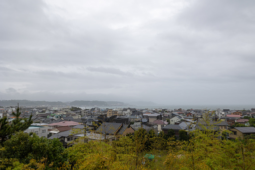 Kamakura, Kanagawa Prefecture, Japan - May 7, 2023 : Cityscape and bay from Hasedera temple on a rainy day