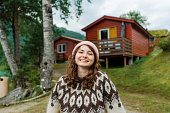 Woman in knitted sweater standing in Norwegian countryside
