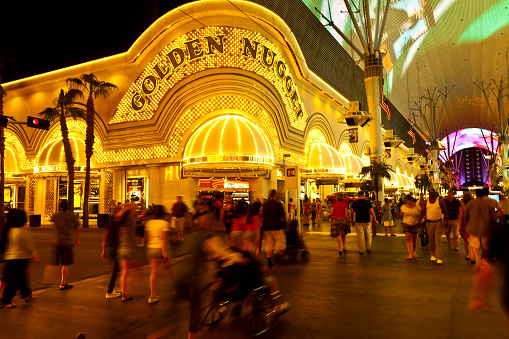 Golden nugget casino enter in Las Vegas by night, people crowd in front. Freemont street.