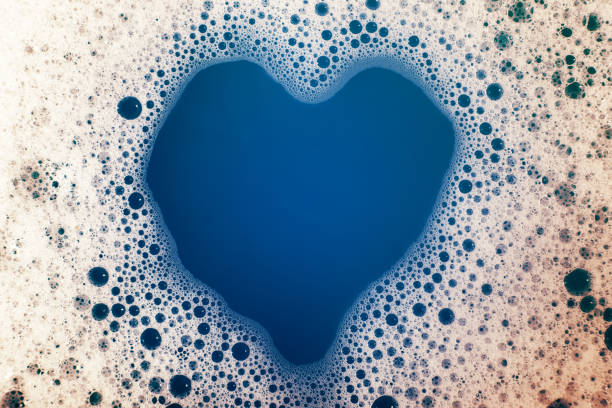 istock thick bubbling soap suds on the surface of the water. trendy colors, gradient. Macro. Texture of soap bubbles, foam 1494300027