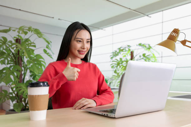 istock Beautiful woman using laptop at cafe 1494305769