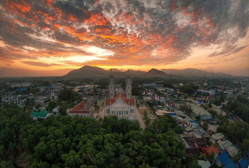 Drone view Song Vinh cathedral lights on in sunrise - Tan Thanh district, Ba Ria Vung Tau province, south Vietnam