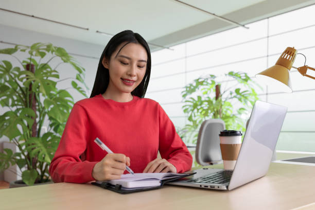 istock Beautiful woman using laptop at cafe 1494308197