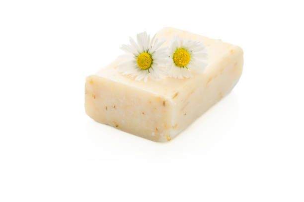 Natural cosmetics concept. stack of handmade soap and chamomiles flowers.
