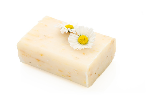 Natural cosmetics concept. stack of handmade soap and chamomiles flowers.
