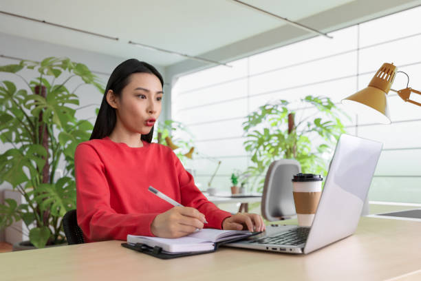 istock Beautiful woman using laptop at cafe 1494311095