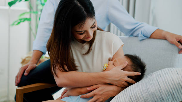 istock Little Infant Boy Sleeping in Mother's Embrace. 1494311514