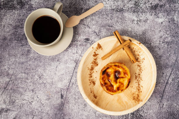 pasteis de nata, typische süßigkeit aus lissabon, portugal, neben einer tasse kaffee, draufsicht. - egg tart stock-fotos und bilder