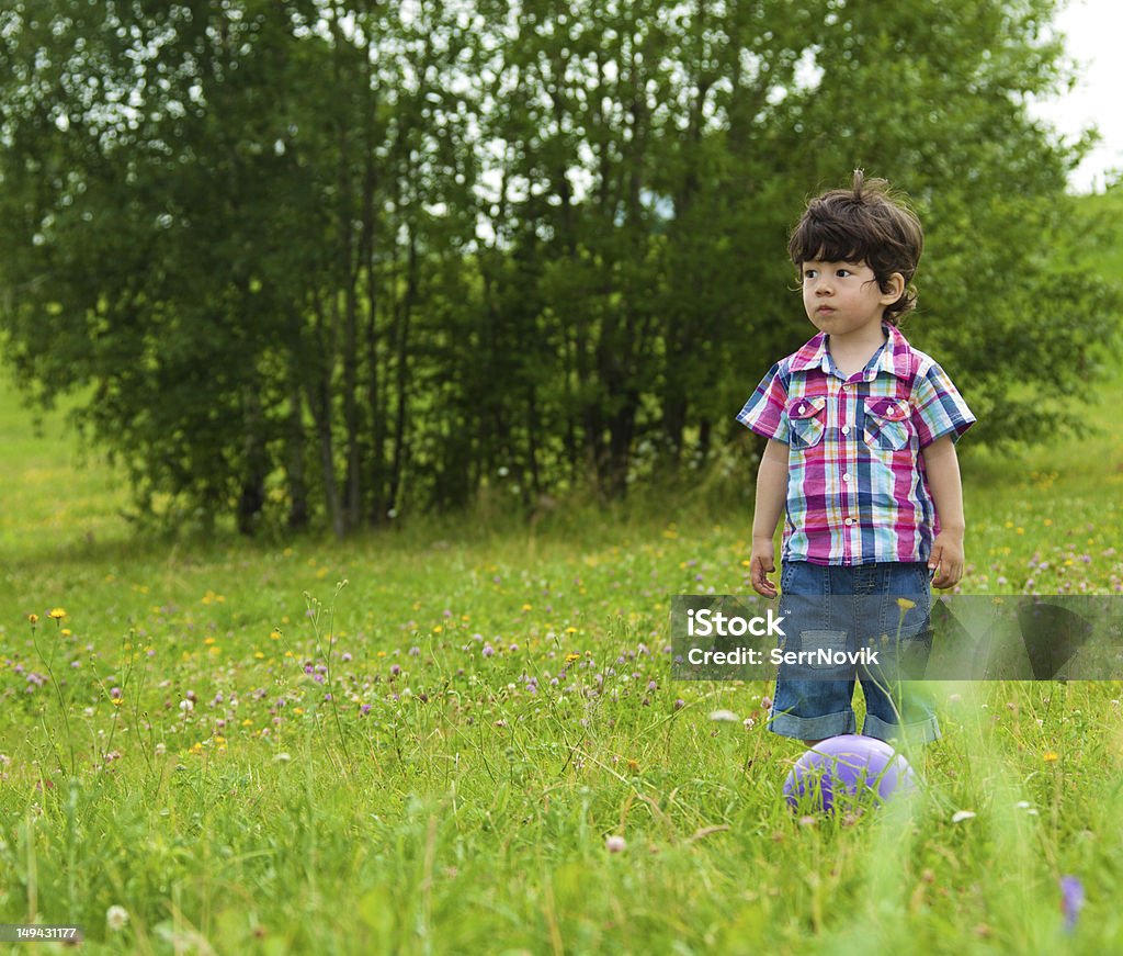 sad boy waiting friend to play sad boy waiting friend in the park to play football 12-17 Months Stock Photo