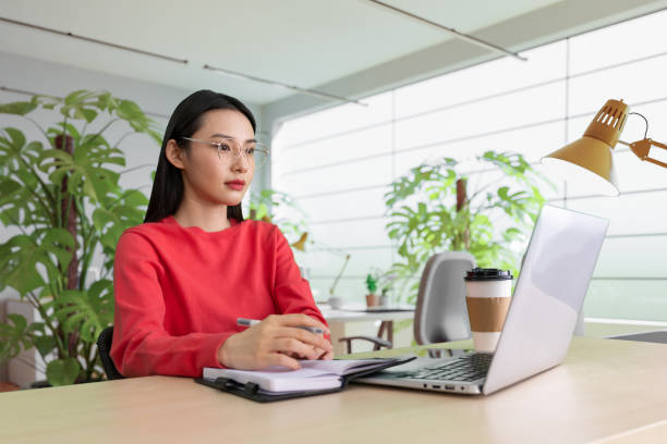 istock Beautiful woman using laptop at cafe 1494311857