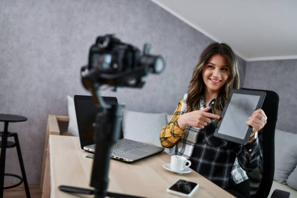 istock Cute Smiling Female Reviewing New Digital Tablet In Vlog 1494312190