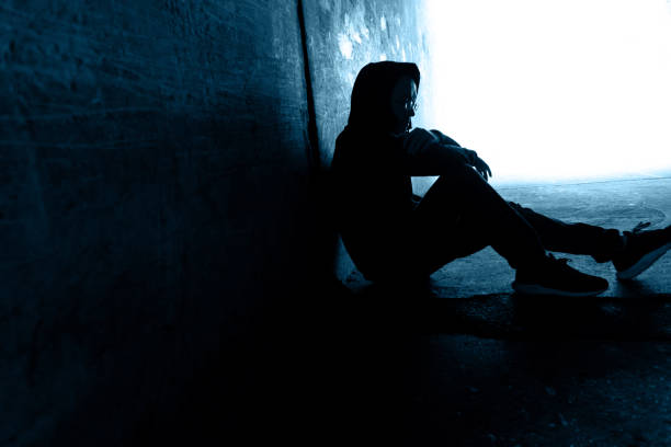 One man sitting in the dark tunnel.