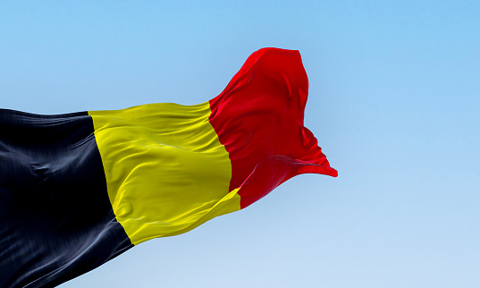 The national flag of Belgium waving on a clear day. Three equal vertical bands: black, yellow and red. 3d illustration render. European country. Rippled fabric.