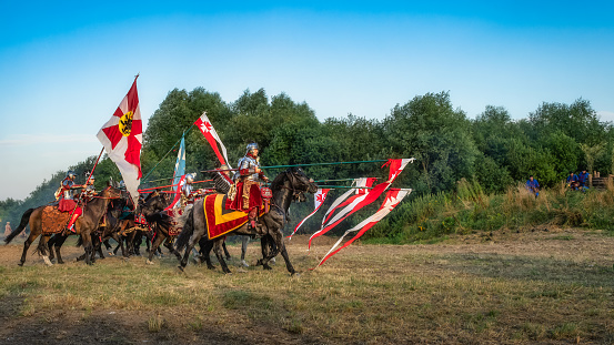 Gniew, Poland, Aug 2020 Hussars holding long lances and charging on enemies, Polish heavy cavalry, historical reenactment, Battle of Gniew