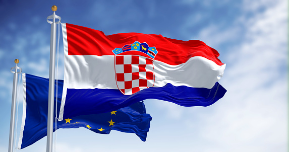 Las banderas de Croacia y la Unión Europea ondeando juntas en un día claro photo